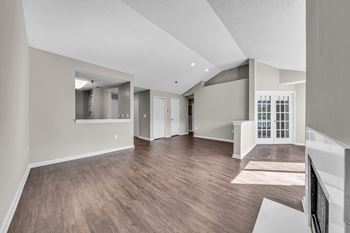 the living room and dining room of a new home with hardwood flooring at Trophy Club at Bellgrade, Midlothian, VA, 23113
